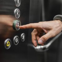 delivery-man-with-package-elevator-close-up