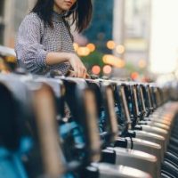 girl renting a city bike from a bike stand in chicago